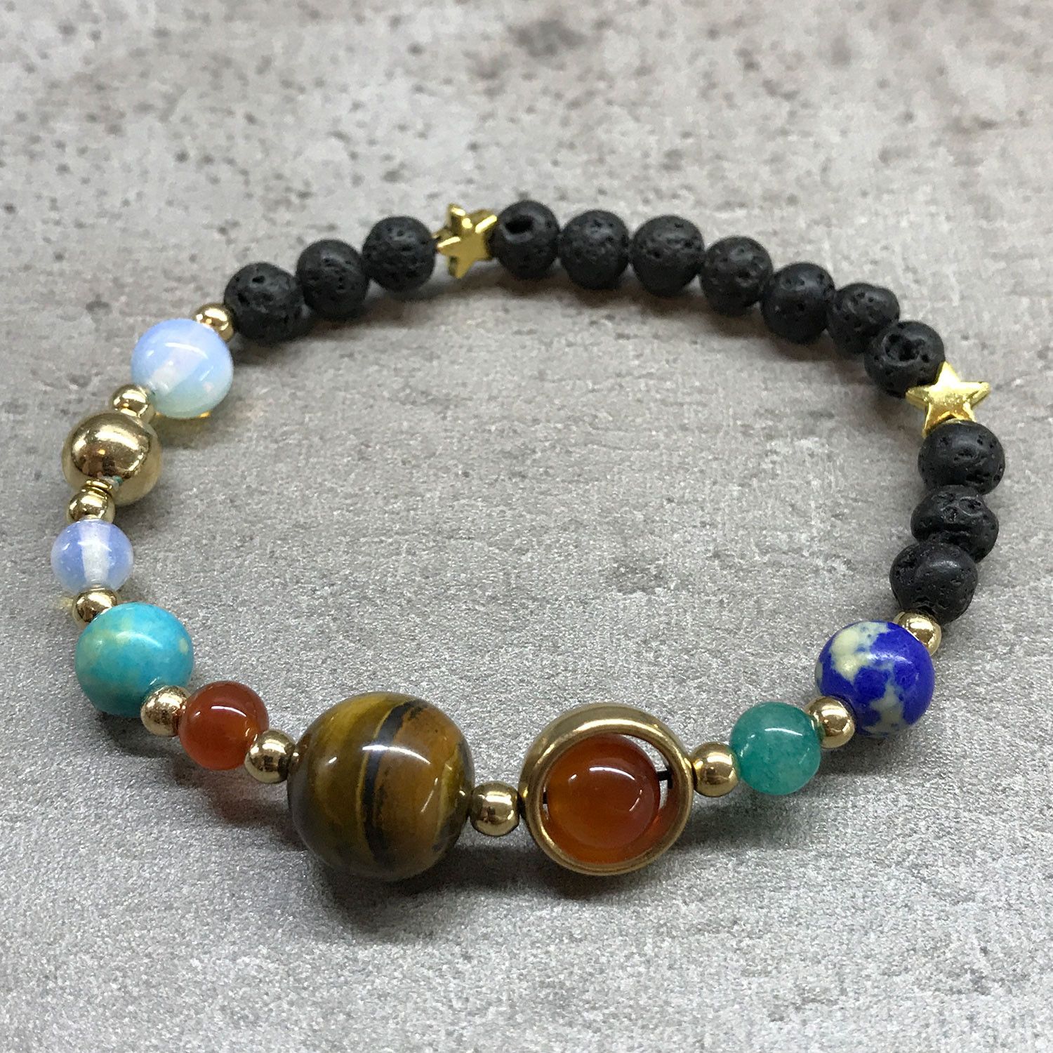 bG9jYWw6Ly9tZWRpYS8xTS9KQy82MFIzMEMxRzZNVDNKQzFNLzQ3M2I5OTY5LmpwZWc.jpg Lava Stone Bracelet - Gold Solar System - Image 2