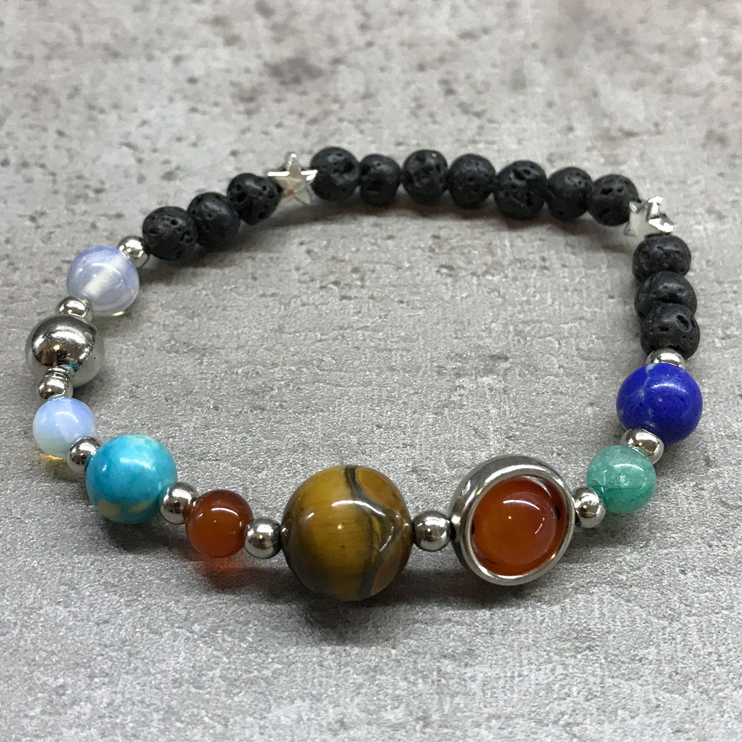 bG9jYWw6Ly9tZWRpYS8xUC9KQy82MFIzMEMxRzZNVDNKQzFQLzczNTAxMmFhLmpwZWc.jpg Lava Stone Bracelet - Silver Solar System - Image 2